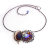 The dendritic agate and blue opal necklace shown on white with chain arranged in a circle.