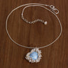 Turquoise heart pendant surrounded by clustered pearls on a silver chain.